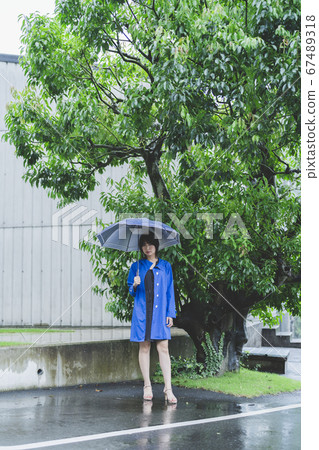 Woman in a raincoat Woman in a raincoat 67489318