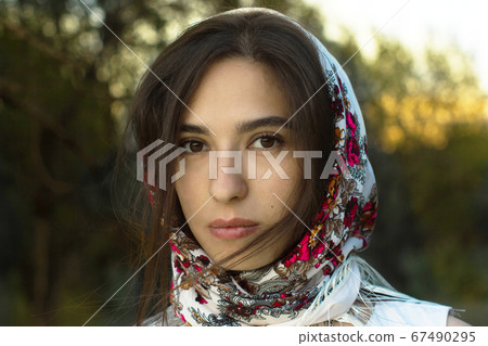 Russian woman in shawl on her head 67490295
