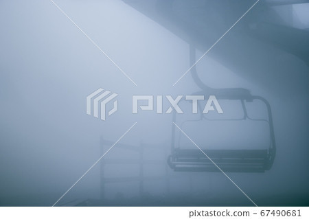 Ski lift chair and foggy weather Ski lift chair and foggy weather 67490681