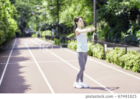 Young woman stretching in sportswear 67491825