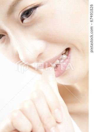 A woman biting a nail 67491826