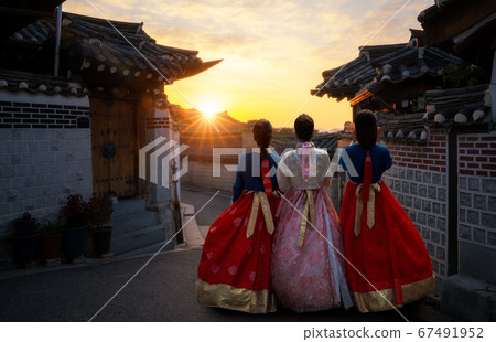Korean girl in hanbok dress with morning at 67491952