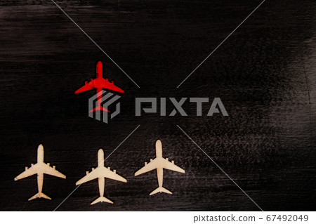 Wooden cutout planes with red plane in front Wooden cutout planes with red plane in front 67492049