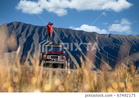 Man Traveller take a photo on a vintage off road 67492175