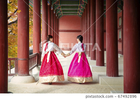 Asian girl walk in autumn leaves park and old 67492896