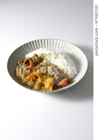 Curry and rice containing a lot of steamed potatoes, carrots and beef tendon (white background) 67493191