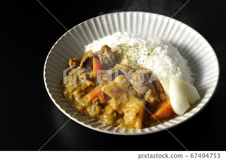 Hot curry rice with plenty of potatoes, carrots and beef tendon meat taken on a black background Hot curry rice with plenty of potatoes, carrots and beef tendon meat taken on a black background 67494753