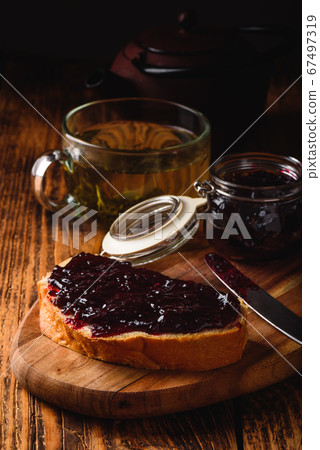 Toast with berry jam and green tea 67497319
