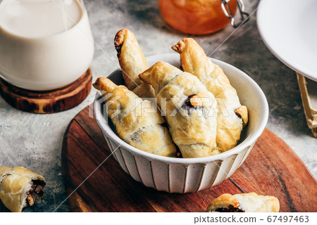 Croissants stuffed with nuts and chocolate spread 67497463