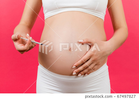 Cropped image of pregnant woman making insulin 67497827