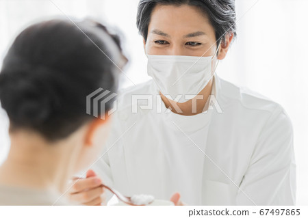 Nursing staff wearing masks to help with meals Nursing staff wearing masks to help with meals 67497865