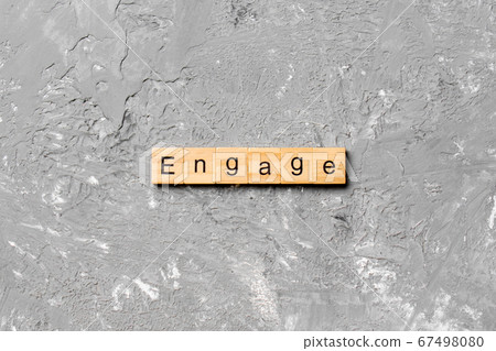 ENGAGE word written on wood block. ENGAGE text on ENGAGE word written on wood block. ENGAGE text on 67498080