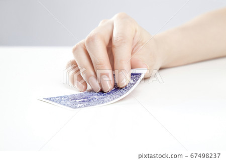 Hand flipping playing cards 67498237