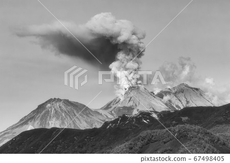 Mountain landscape, dramatic view of eruption of volcano, plume of gas, steam, ashes from crater Mountain landscape, dramatic view of eruption of volcano, plume of gas, steam, ashes from crater 67498405