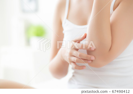 Closeup elbow of beautiful asian woman applying skincare and moisturizer cream or treatment. Closeup elbow of beautiful asian woman applying skincare and moisturizer cream or treatment. 67498412