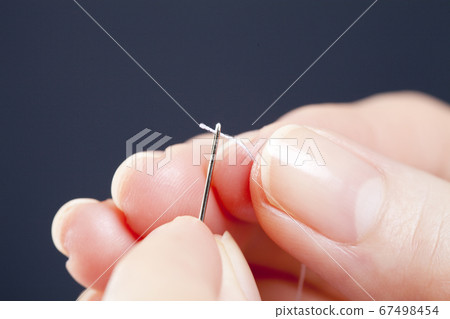 A woman sewing 67498454