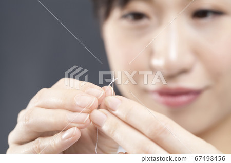 Female hands sewing 67498456