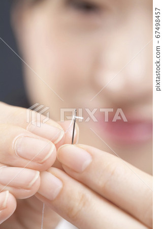 Female hands sewing Female hands sewing 67498457