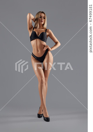 Woman on heels posing in lingerie. 67499181