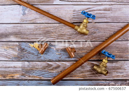Set of brass plumbing fitting tools on wooden Set of brass plumbing fitting tools on wooden 67500637
