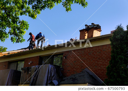 Construction worker on renovation roof the house 67500793