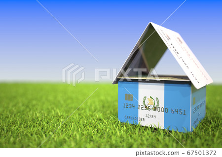National flag of Guatemala on credit card house in the grass. Home loans related 3D rendering National flag of Guatemala on credit card house in the grass. Home loans related 3D rendering 67501372