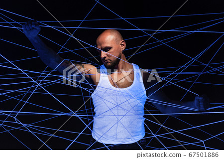 Photo of looking down man tangled in white threads in ultraviolet Photo of looking down man tangled in white threads in ultraviolet 67501886