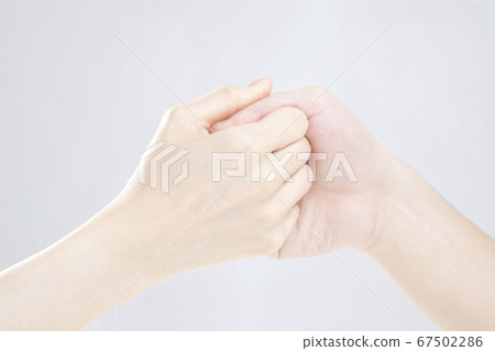 Men and women doing finger wrestling Men and women doing finger wrestling 67502286