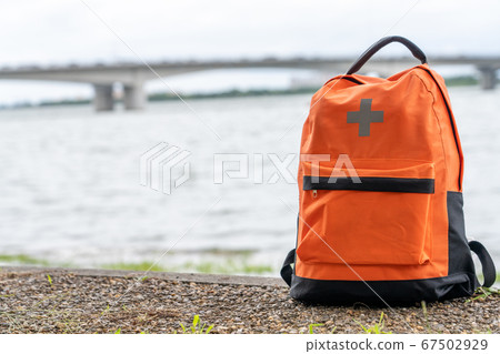 Disaster prevention rucksack placed on the waterside 67502929