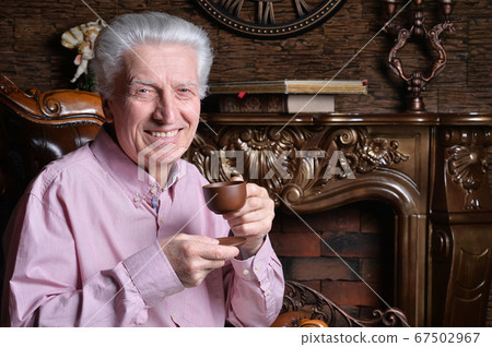 Close-up portrait of senior man drinking tea Close-up portrait of senior man drinking tea 67502967
