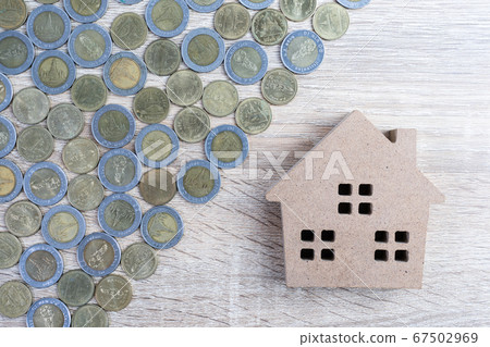 Top view house and coins on wood table Top view house and coins on wood table 67502969