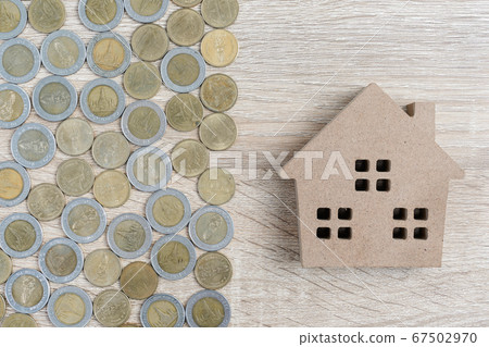 Top view house and coins on wood table Top view house and coins on wood table 67502970