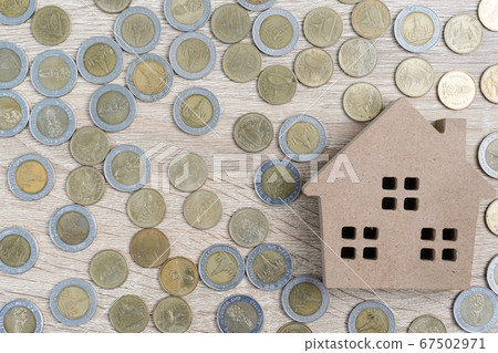 Top view house and coins on wood table 67502971