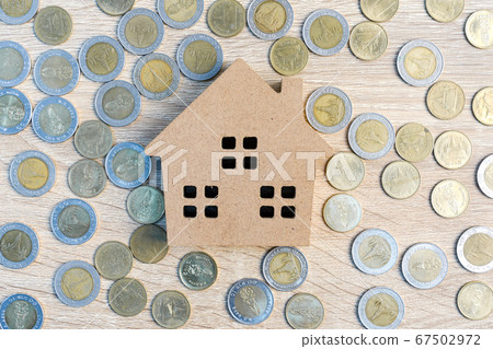 Top view house and coins on wood table Top view house and coins on wood table 67502972