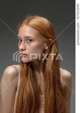 Portrait of beautiful redhead woman isolated on grey studio background. Concept of beauty, skin care, fashion and style 67503094