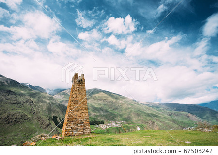 Sioni, Georgia. Ancient Old Stone Watchtower On Mountain Background In Sioni Village, Kazbegi District, Mtskheta-Mtianeti Region, Georgia. Spring Or Summer Season. Famous Landmarks And Places In 67503242