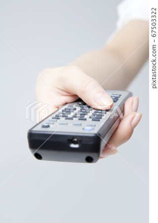 Hand holding remote control Hand holding remote control 67503322