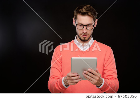 Using tablet against black background 67503350