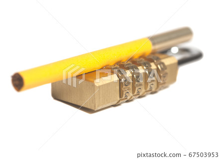 Yellow cigarette and a padlock.Tobacco addiction Yellow cigarette and a padlock.Tobacco addiction 67503953