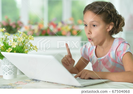 Cute girl has an idea while using laptop at home Cute girl has an idea while using laptop at home 67504068
