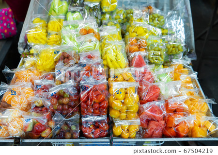 Street food market in Asia. Fruit packaged in mini Street food market in Asia. Fruit packaged in mini 67504219