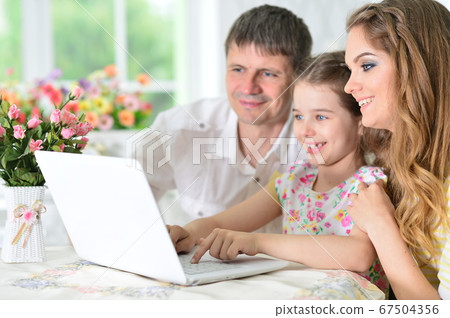 Girl with mother and father drawing at home Girl with mother and father drawing at home 67504356