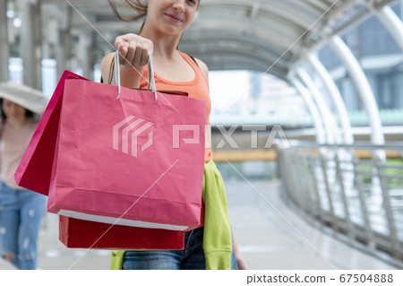 Shopaholic Women holding shopping bags ,money 67504888