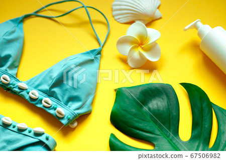 set of summer beach accessories on a yellow background 67506982