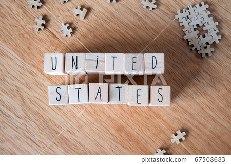 Country The United States of America written on wooden cubes on wooden background 67508683