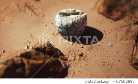 old football ball on the sand beach 67508695