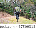 A man who advances camping equipment on a bicycle 67509313