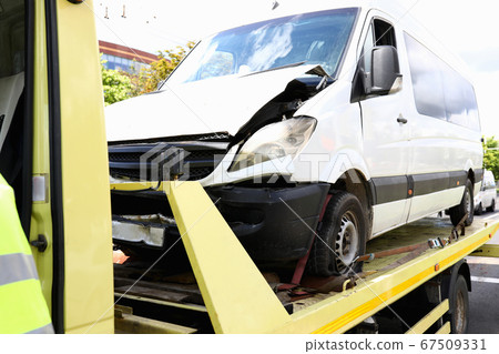 Wrecked car stands on tow truck closeup. 67509331