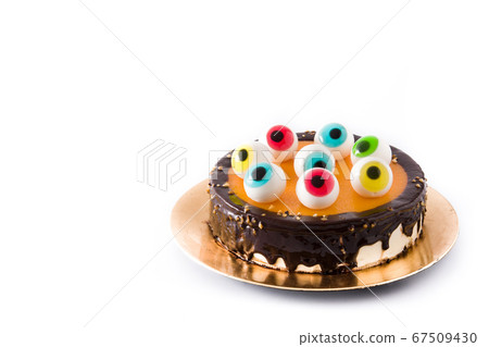 Halloween cake with candy eyes decoration isolated on white background.. Copy space Halloween cake with candy eyes decoration isolated on white background.. Copy space 67509430