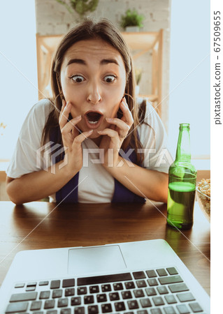 Excited football fan watching sport match at home, remote support of favourite team during coronavirus pandemic outbreak 67509655